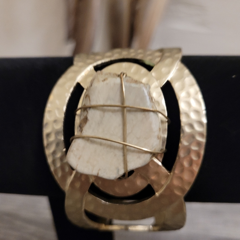 Hammered gold toned bracelet with stone